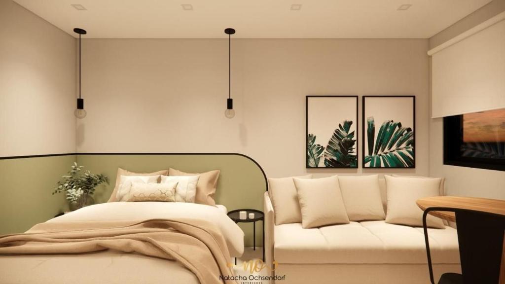 a bedroom with a bed and a couch at One Studios Indaiatuba in Indaiatuba