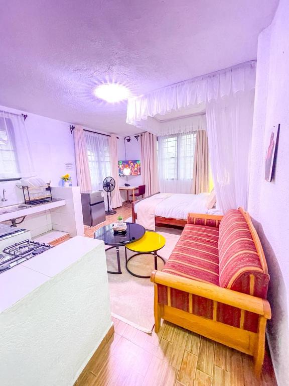 a large living room with a bed and a table at R 19 Kogelo Villas in Kisumu