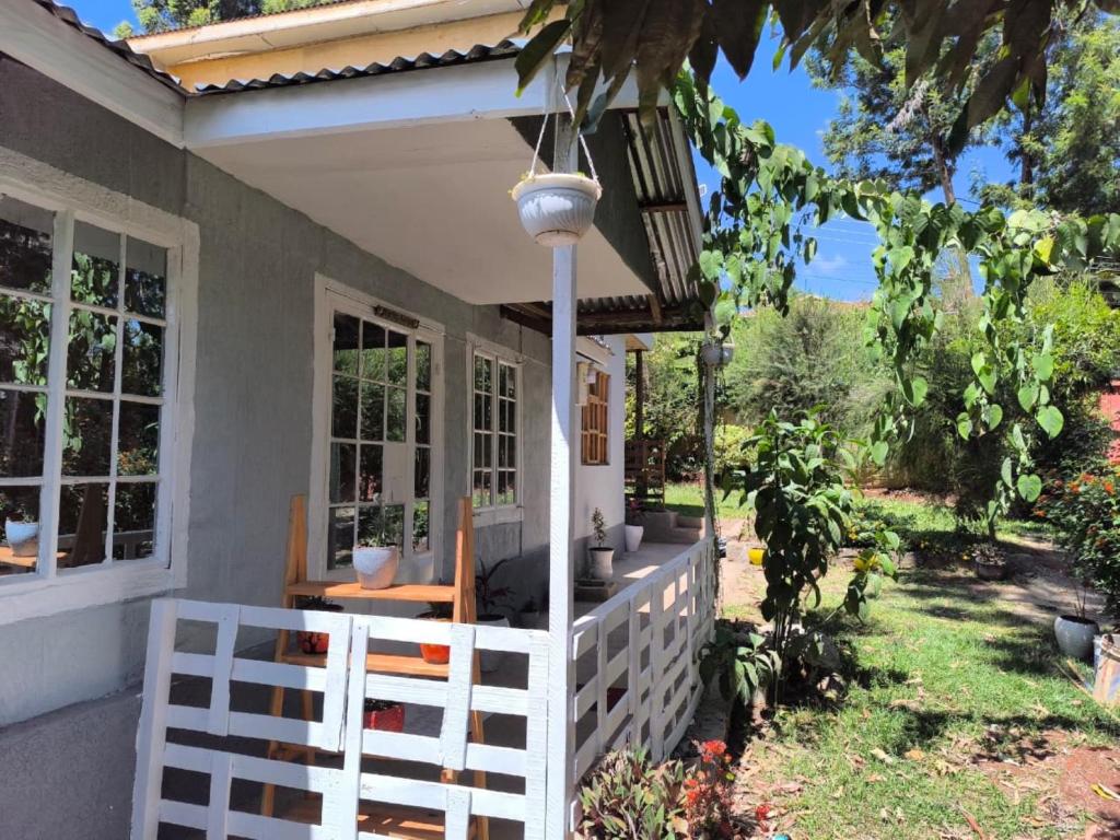 a porch of a house with a white fence at Mizpah House in Kikuyu