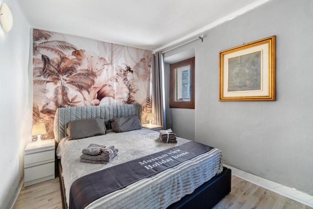 a bedroom with a bed with a mural on the wall at Museum View, vista sul museo in Sassello