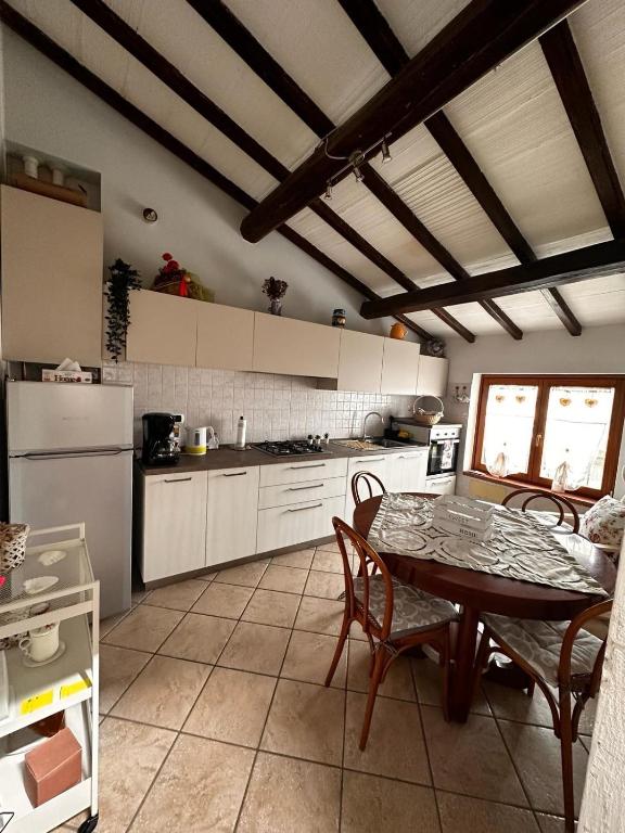 a kitchen with a table and chairs in a kitchen at Flat in Chiesina Uzzanese in Chiesina Uzzanese