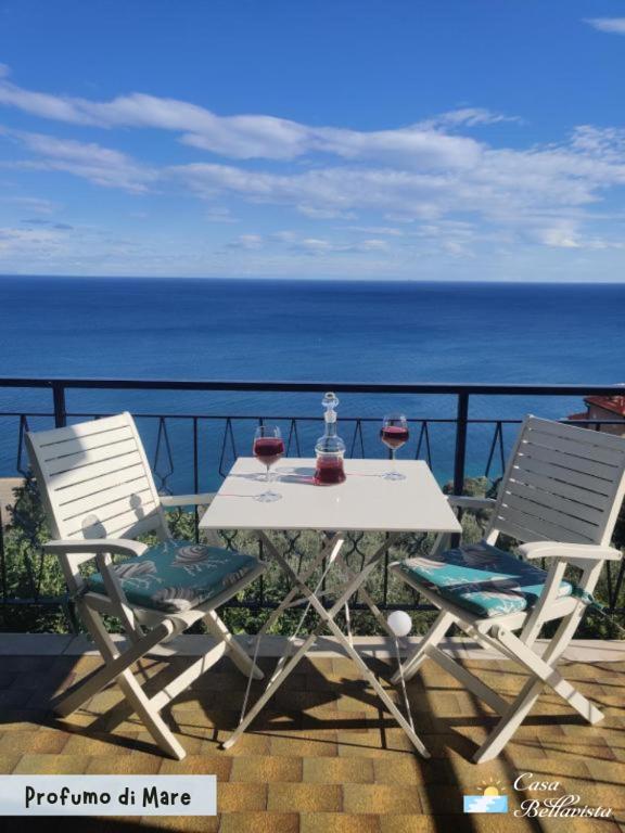 a white table and two chairs with wine glasses on it at Casa Bellavista in Bergeggi