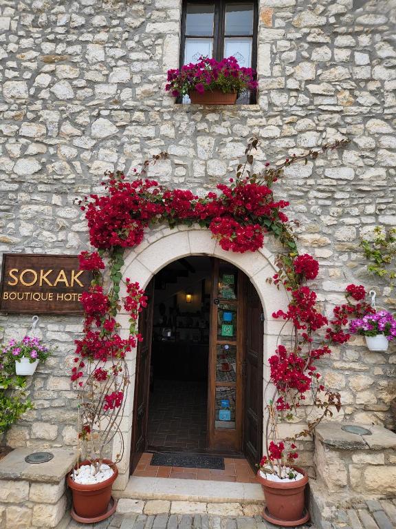 an entrance to a building with flowers on it at Sokak Boutique Hotel in Berat