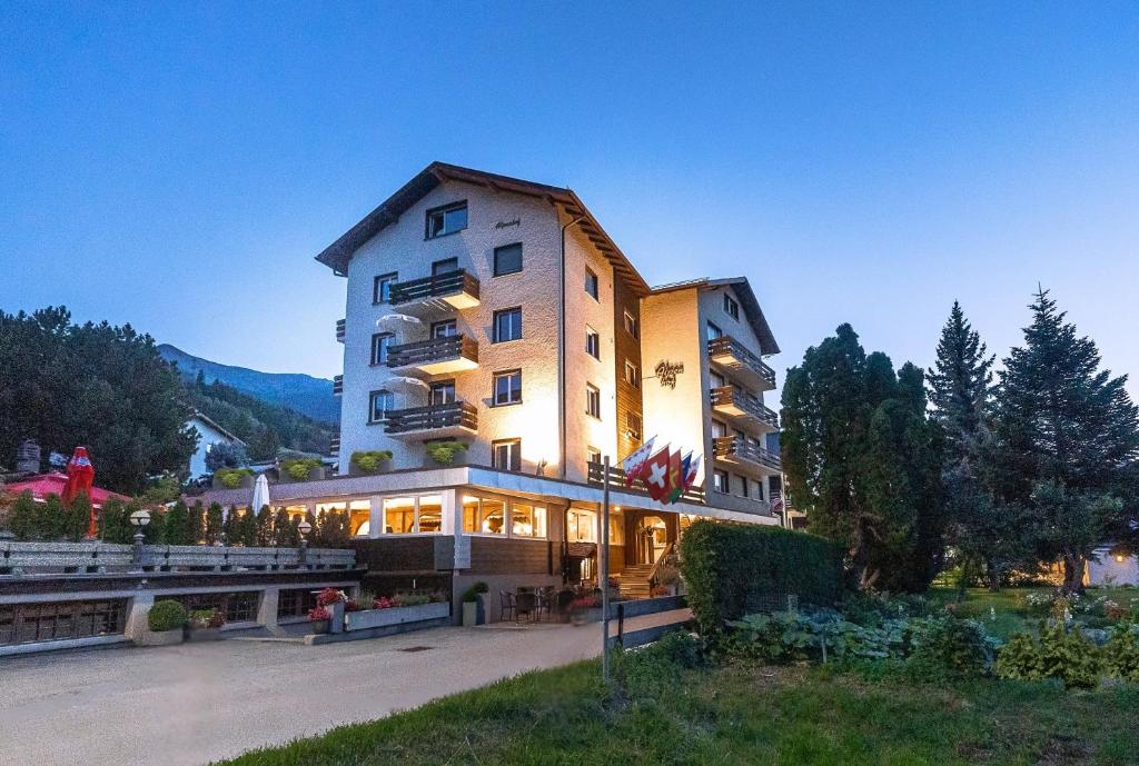 a large building with a lot of lights on it at Hotel Alpenhof in Unterbäch