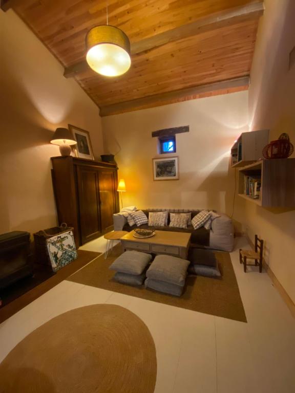 a living room with a couch and a table at La cabane de Thuriès in Camarès