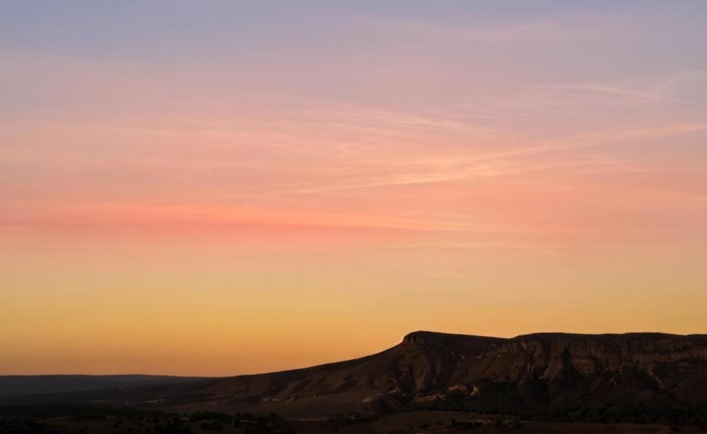 a sunset over a mountain in the desert at Sky Lodge in Hartbeespoort