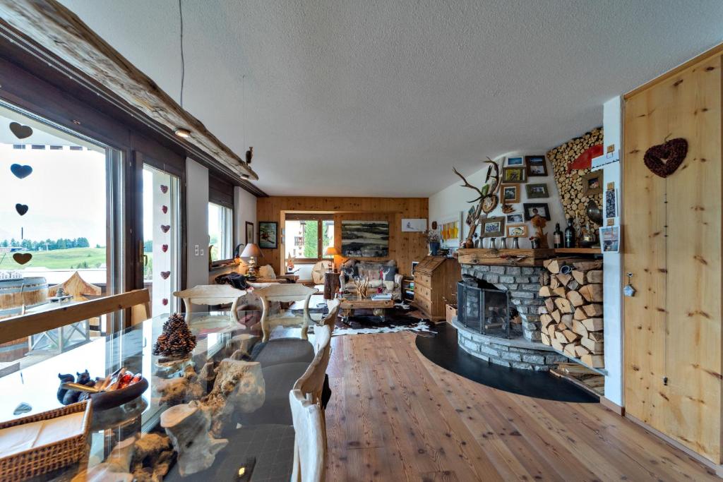 a living room with a couch and a fireplace at Chesa Flurigna - Zuoz in Zuoz