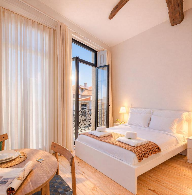 a bedroom with a bed and a large window at FindMe InPorto Bonfim in Porto
