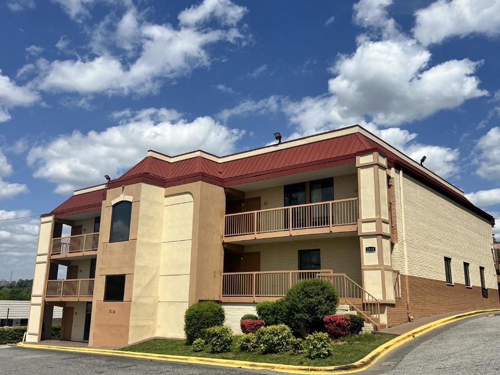a large apartment building with a red roof at UNIVERSITY INN Winston in Winston-Salem