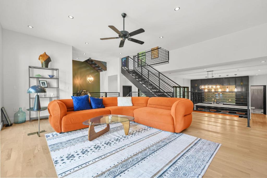 a living room with an orange couch and a table at Music Soul House in Atlanta