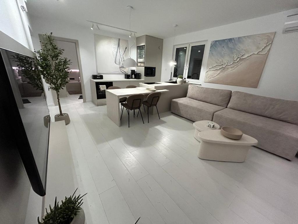 a living room with a couch and a table at Apartamenty Blanca in Łeba