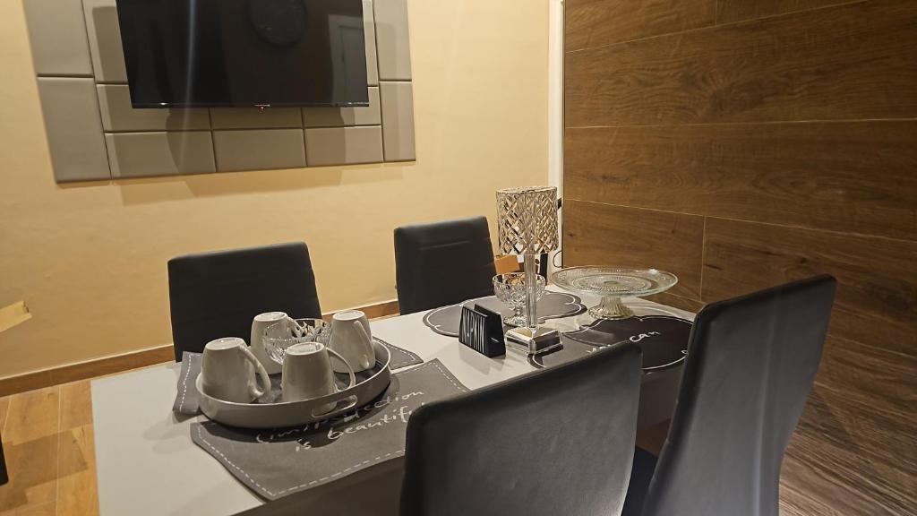 a dining room with a table with chairs and a television at Guest house Di Carlo in Sulmona