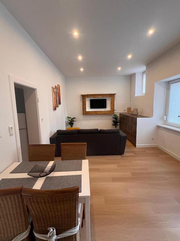 a living room with a couch and a table at Apartment Rosenberg in Klotten