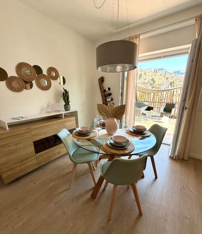 a dining room with a table and chairs in a room at Al Nio in Baselga di Pinè