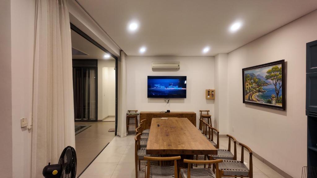 a dining room with a wooden table and chairs at Zenna villa long Hải in Bà Rịa