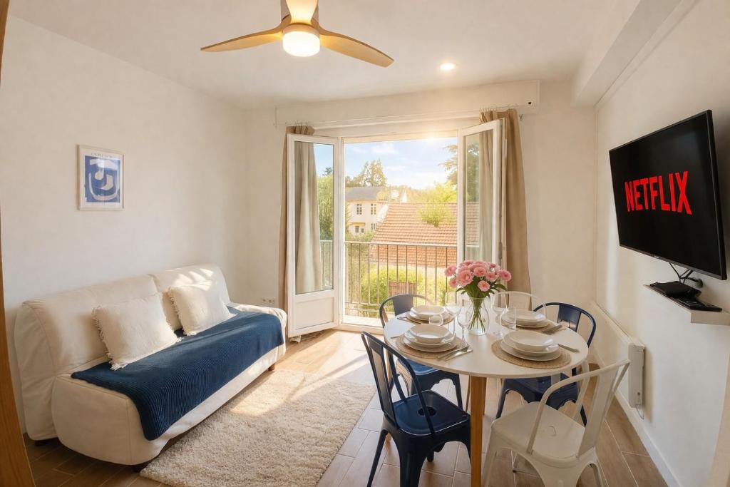 a living room with a couch and a table at Le Blue Hole - Appartement de charme Digoin in Digoin