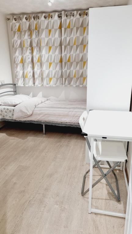 a bedroom with a bed and a desk at Single Room near Science Park in Histon