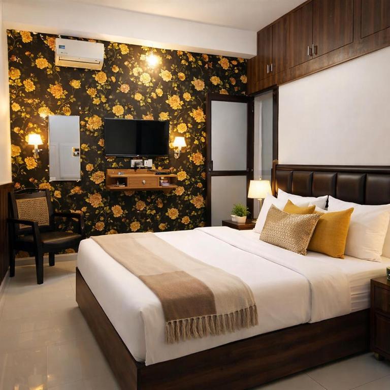 a bedroom with a large bed and a tv at Absolute hostel in Meerut