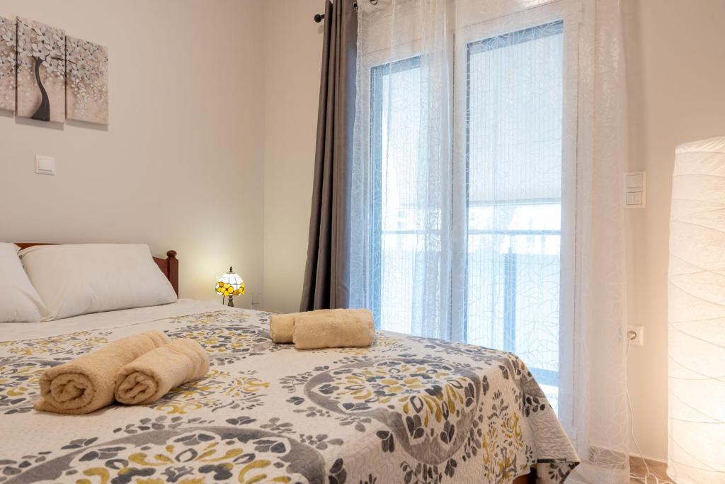 a bedroom with a bed with towels on it at Artemida Beach Apartment 2 in Artemida
