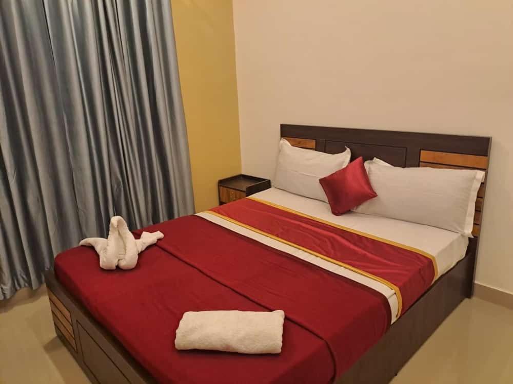 a bedroom with a bed with a stuffed animal on it at W Villas in Padinjarathara