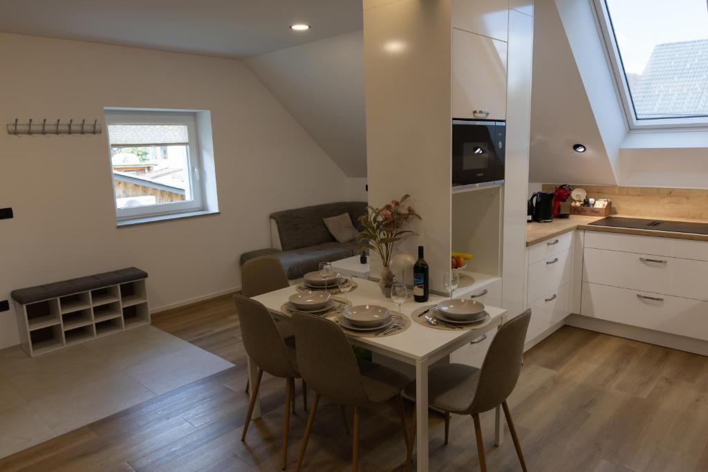 a kitchen and dining room with a table and chairs at Mahne Apartment in Kranj