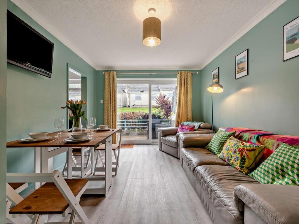 a living room with a couch and a table at 2 Bed in Swansea oc-90367 in Oxwich