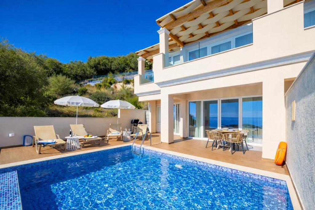 a villa with a swimming pool and a patio at Villa Leo in Barbati