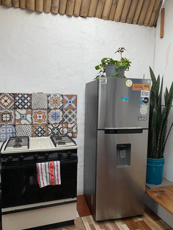 a stainless steel refrigerator next to a stove at El Chirris Tzanjay in San Juan La Laguna