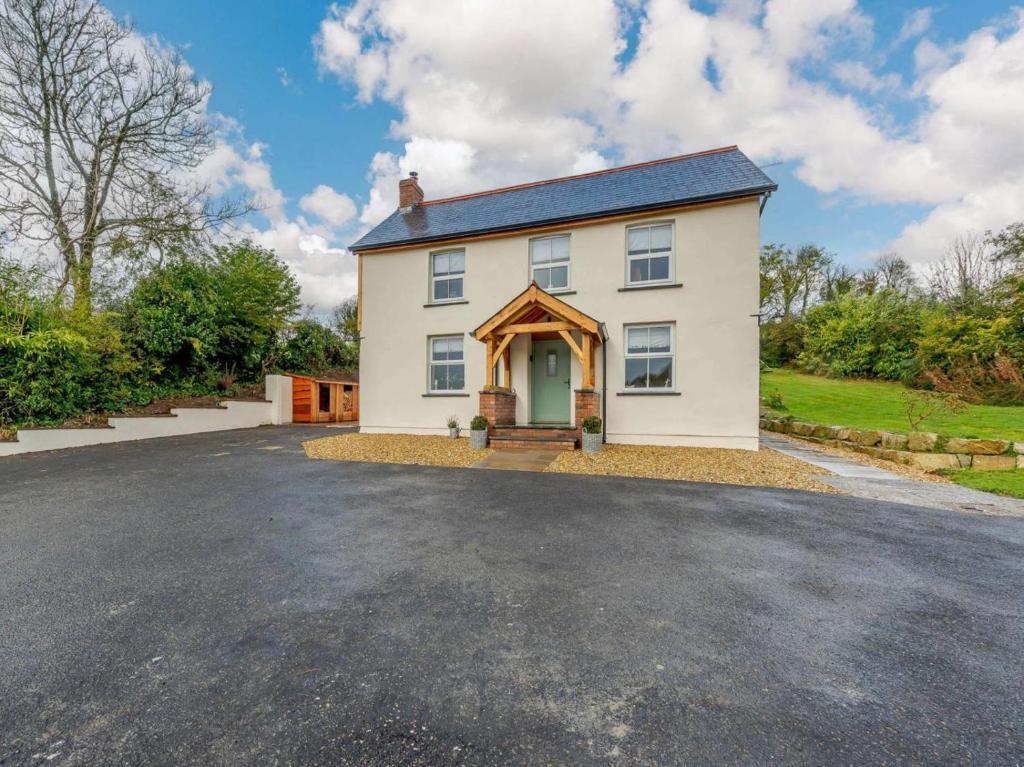 a large white house with a driveway at 3 Bed in Llandysul oc-90019 in Llandyssiliogogo