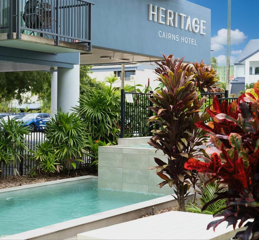 a swimming pool in front of a building at Heritage Cairns Hotel in Cairns
