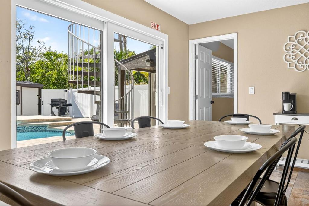 a dining room with a wooden table and chairs at Heated PoolFoosball,Pac Man Arcade, walk to beach in Clearwater Beach
