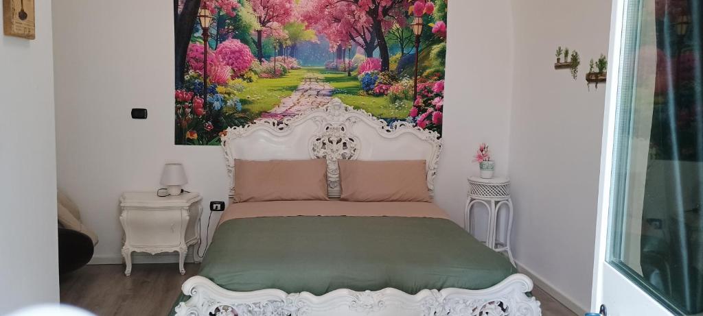 a bedroom with a bed with a painting on the wall at Oasi di san Benedetto in Castellaneta