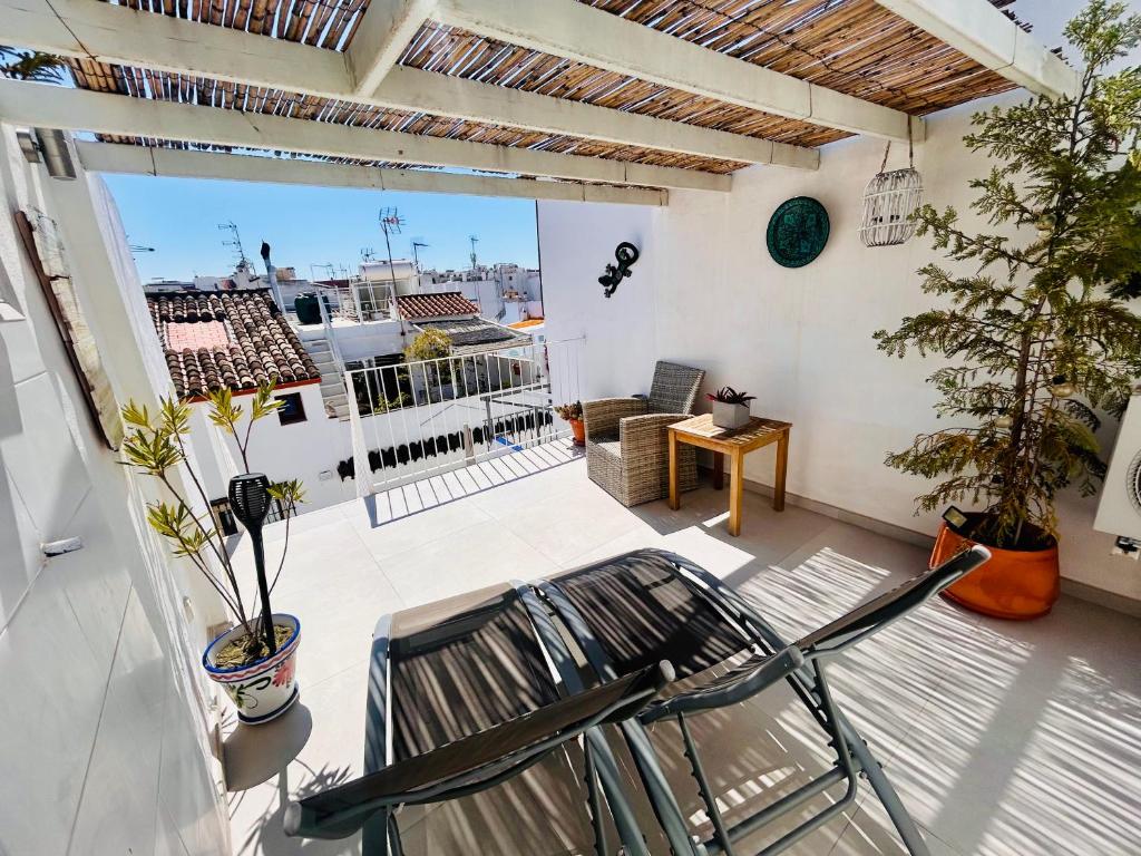 a patio with a chair on a balcony at Fabulous 2 bed-townhouse with large rooftop! in Estepona