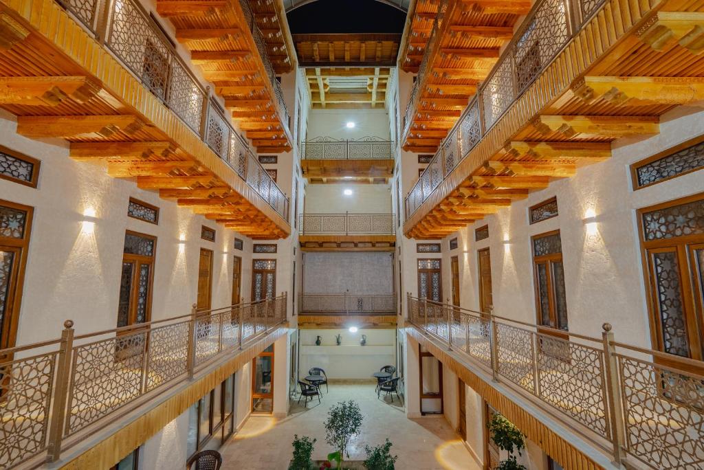 an image of a large building with wooden ceilings at SHakhina premium hotel in old city in Bukhara