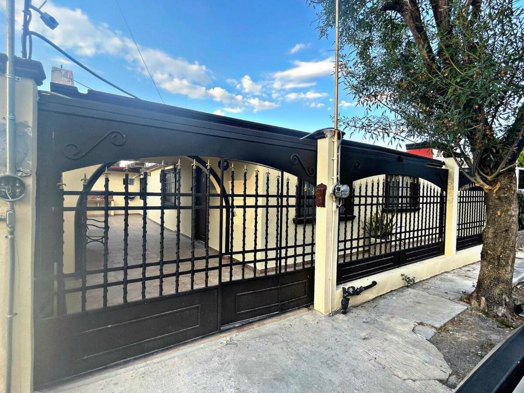 a black fence with a black gate at SN2 Loft for 2 people, private bathroom in Monterrey