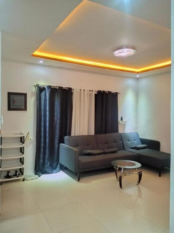 a living room with a couch and a table at Digong Guest House Mulogan in Molugan
