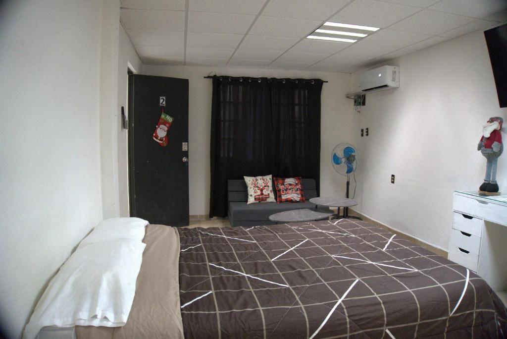 a bedroom with a bed and a couch in it at Comfortable and Centrally Located Accommodation 2 in Altamira