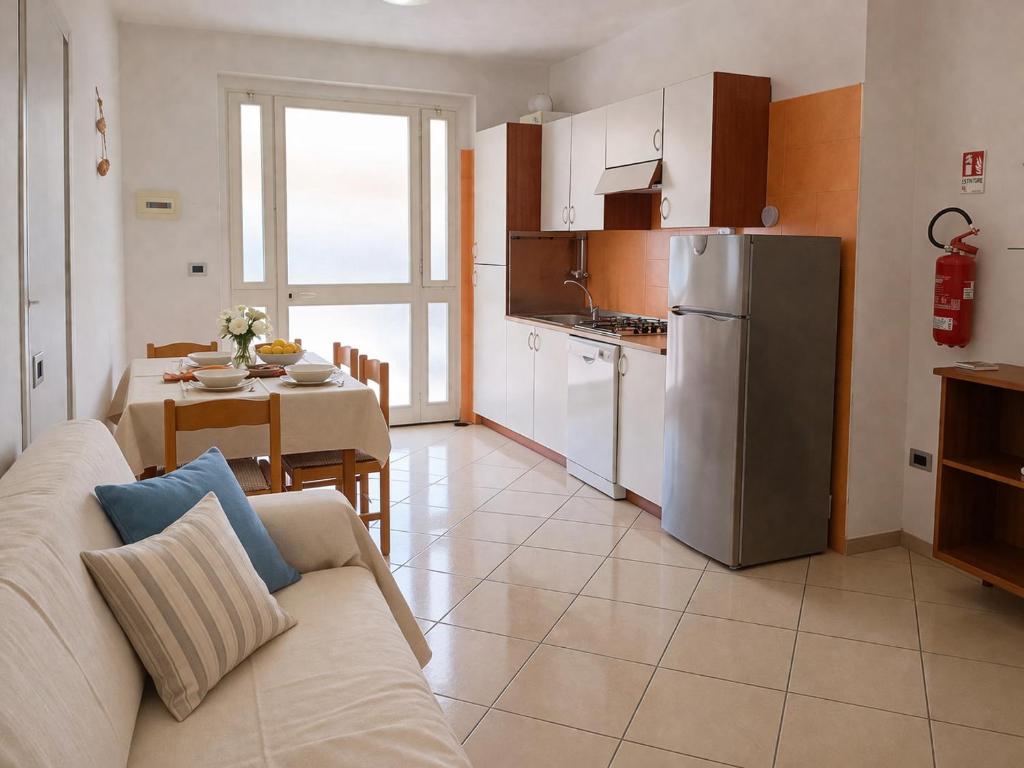 a living room with a couch and a kitchen with a table at Kai beach in Villa Rosa