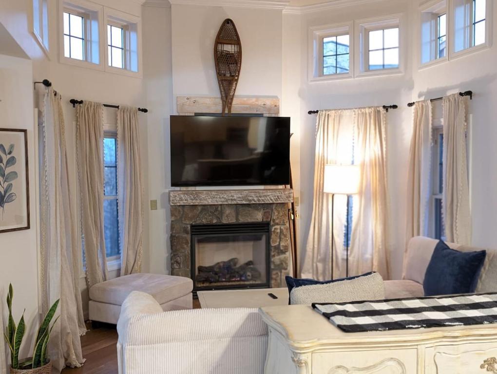 a living room with a fireplace and a tv at Premium 3 Bed Top Floor Views in Vernon Township