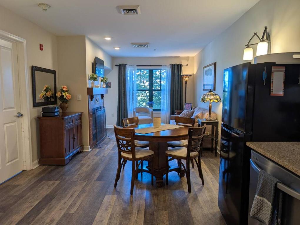 a kitchen and dining room with a table and chairs at Country Charm 1 Bd Balcony Views in Vernon Township