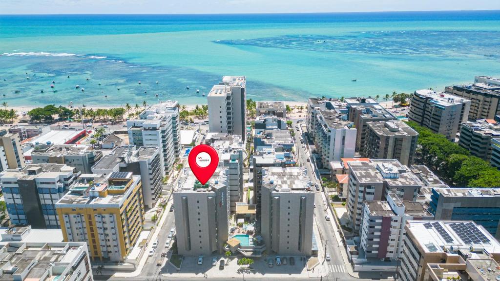 a city with a red sign on top of buildings at San Marino Suite Hotel in Maceió