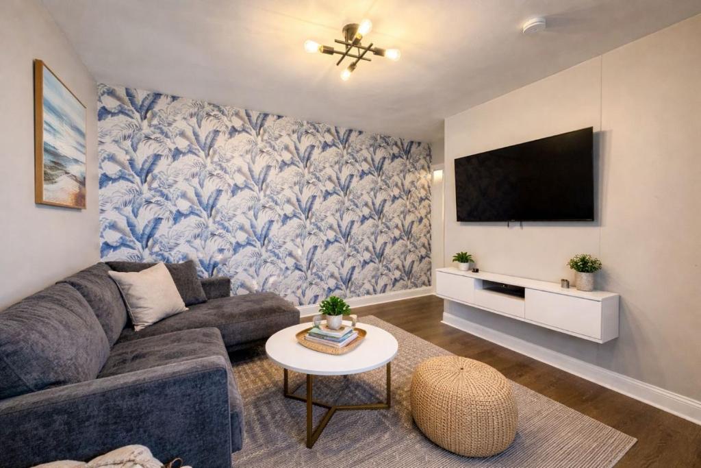 a living room with a couch and a tv at Boutique Hotel Style Steps to Boardwalk in Seaside Heights
