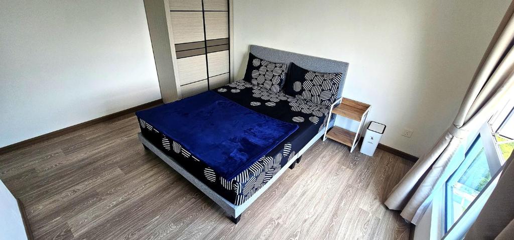 a bedroom with a bed with a blue comforter at Master Room with Private Bath at Kajang in Kajang