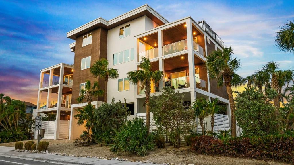 a building with palm trees in front of it at Top Deck Estate in Siesta Key