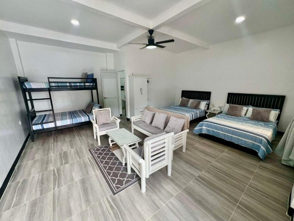 a living room with two beds and a couch at Villa Trajano Resort in San Antonio