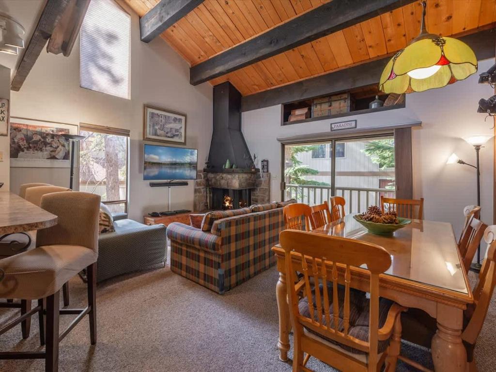a living room with a table and a fireplace at Bear's Den in Kings Beach