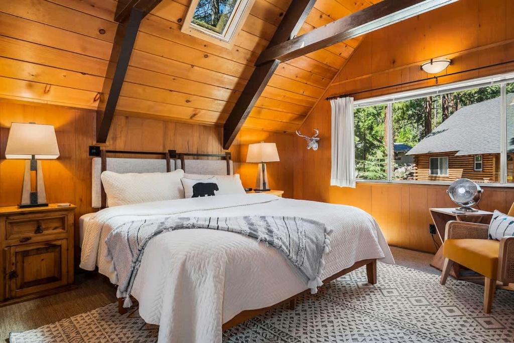 a bedroom with a large bed in a wooden room at Honey Bear Cabin in Carnelian Bay
