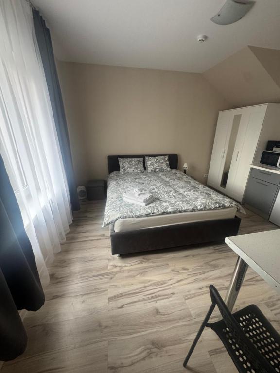 a bedroom with a bed and a wooden floor at Straume in Valmiera