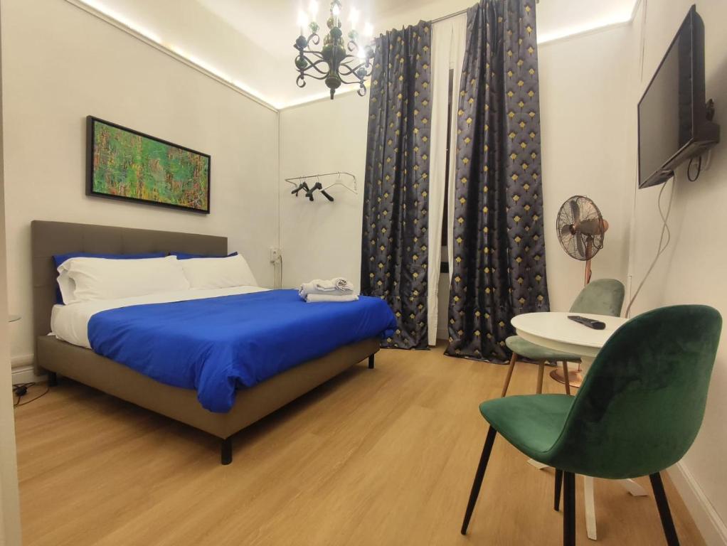 a bedroom with a bed and a table and chairs at Short Lets Grandi Stazioni in Bari