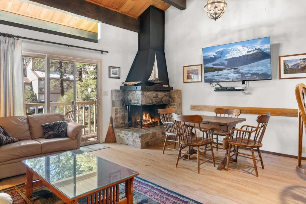 a living room with a table and a fireplace at Corwin's Quarters in Kings Beach